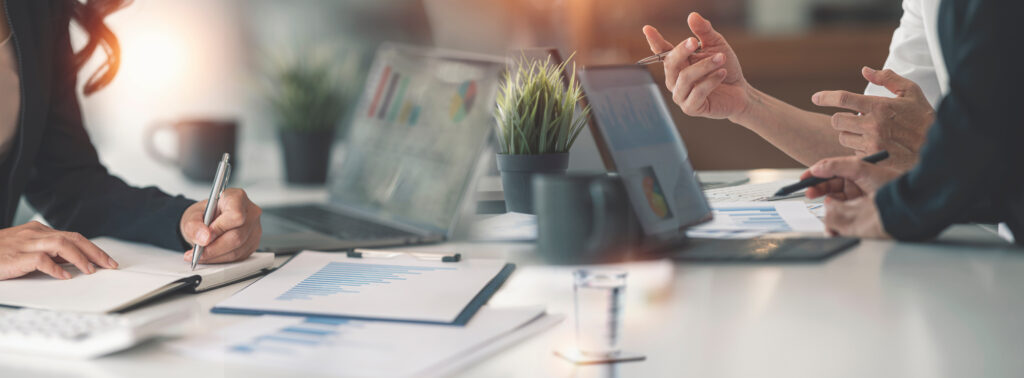 chorus e.v. - Group of business people working, discussing business strategy at office desk.
